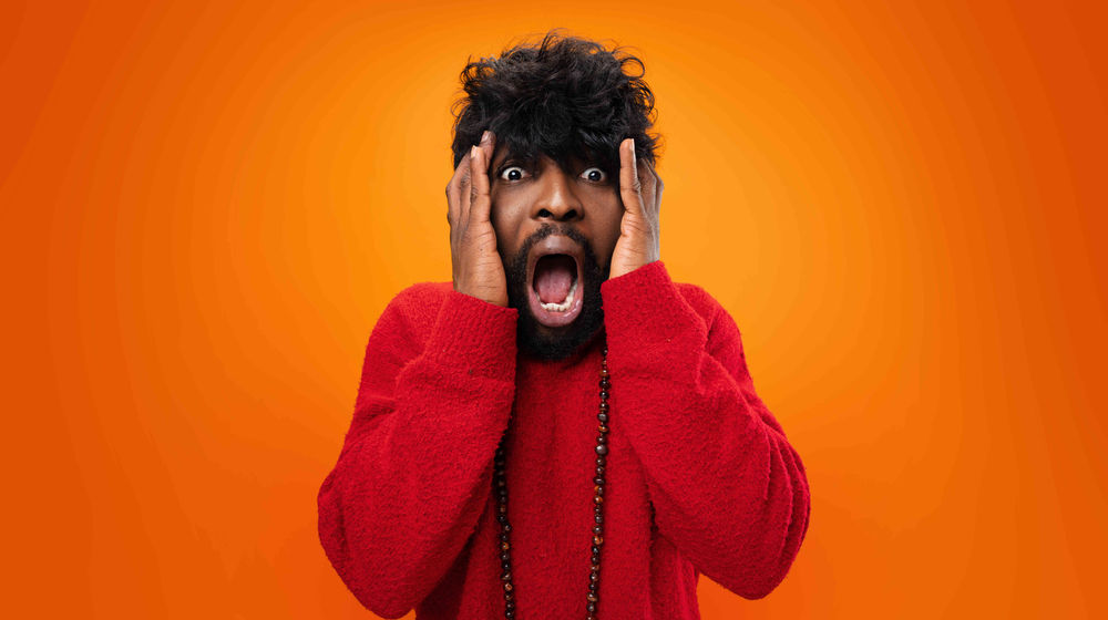 young-thrilled-casual-black-man-screaming-yellow-background (1).jpg