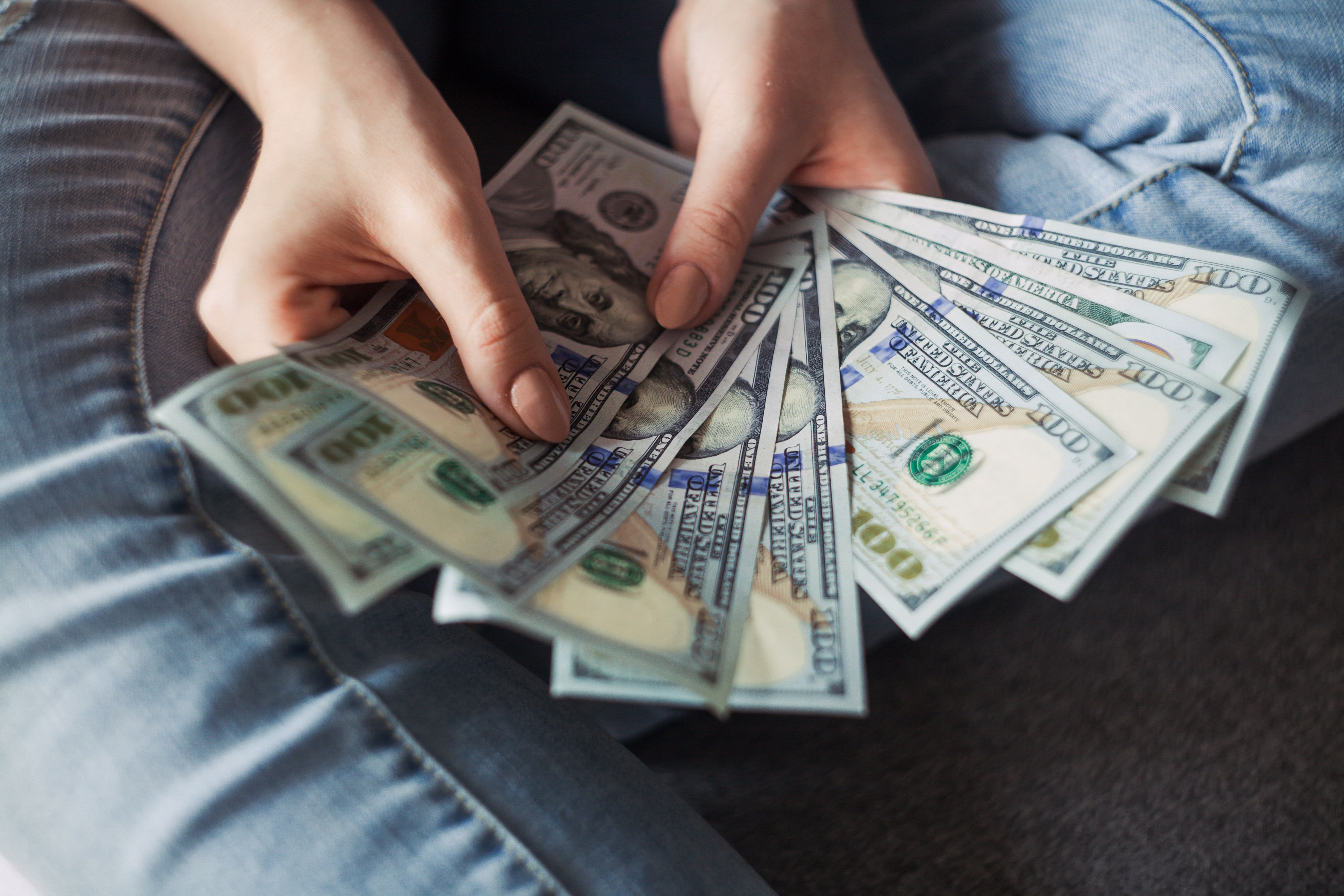 Photo by Alexander Mils: https://www.pexels.com/photo/person-holding-100-us-dollar-banknotes-2068975/