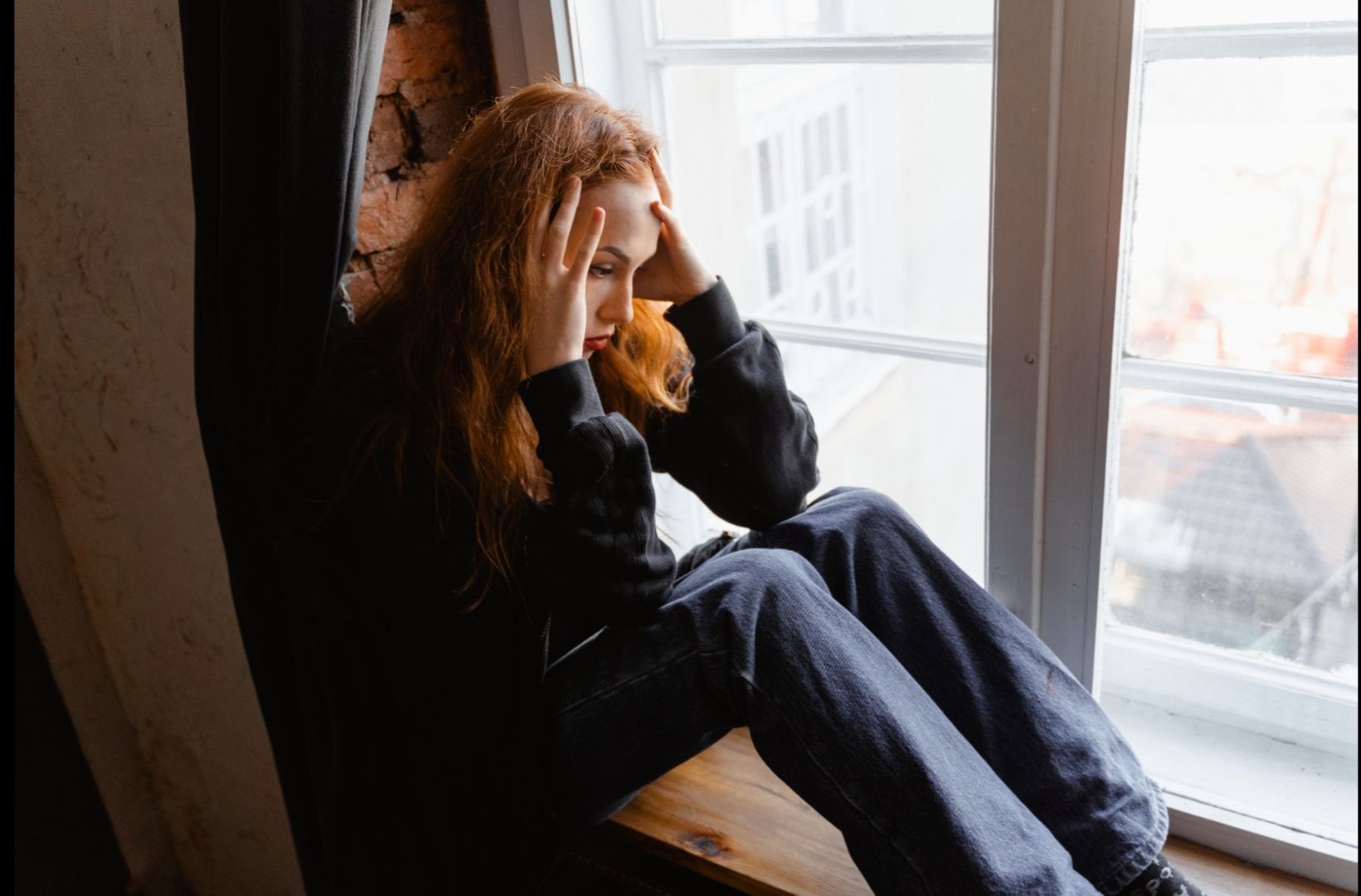 Photo by MART  PRODUCTION: https://www.pexels.com/photo/stressed-woman-sitting-on-window-sill-7278794/
