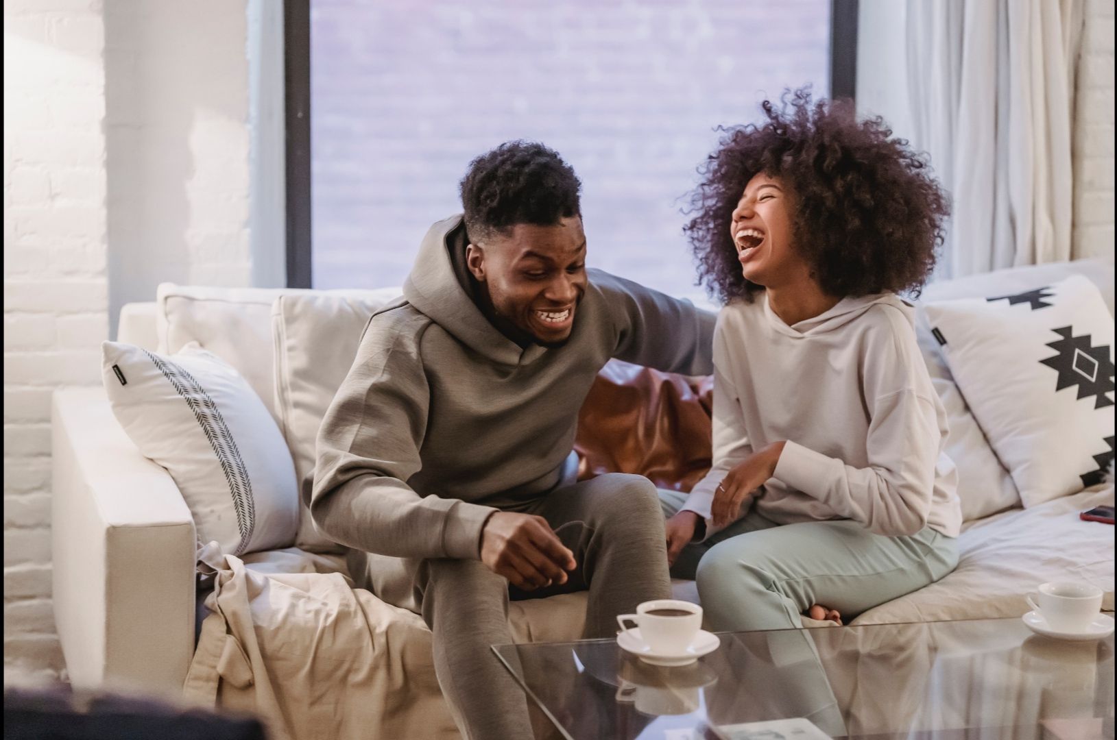 Photo by Andres  Ayrton: https://www.pexels.com/photo/expressive-young-black-couple-having-fun-at-couch-at-home-6579046/