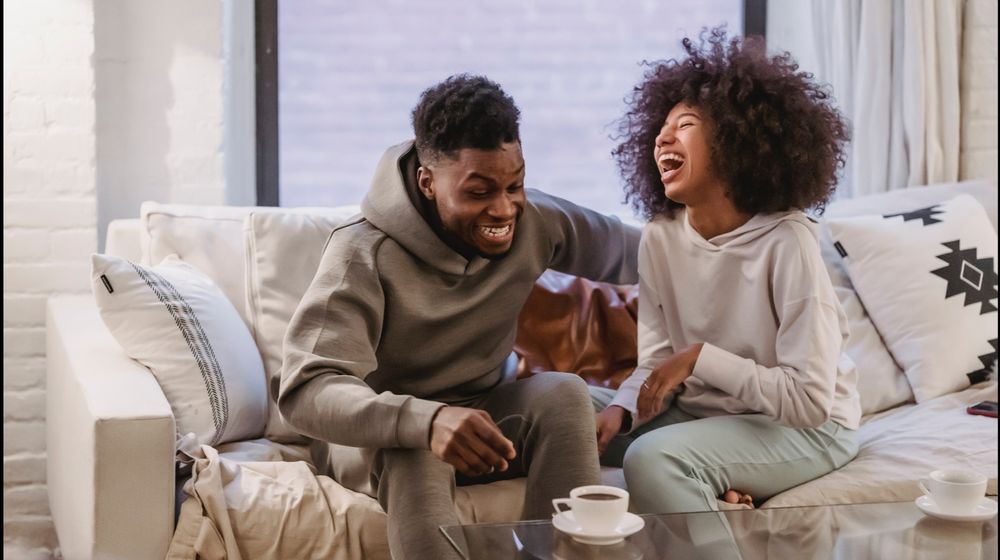 Photo by Andres Ayrton: https://www.pexels.com/photo/expressive-young-black-couple-having-fun-at-couch-at-home-6579046/