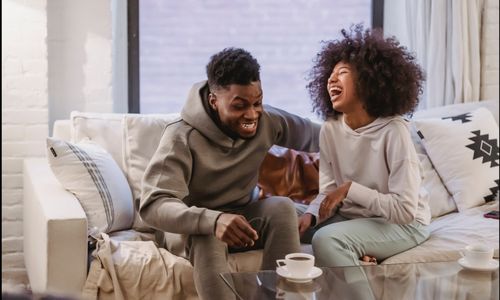Photo by Andres  Ayrton: https://www.pexels.com/photo/expressive-young-black-couple-having-fun-at-couch-at-home-6579046/