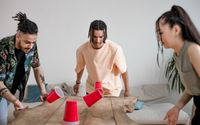 Photo by Ron Lach : https://www.pexels.com/photo/group-of-friends-playing-using-red-plastic-cups-8368342/