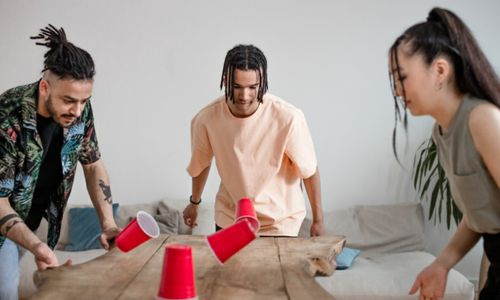 Photo by Ron Lach : https://www.pexels.com/photo/group-of-friends-playing-using-red-plastic-cups-8368342/