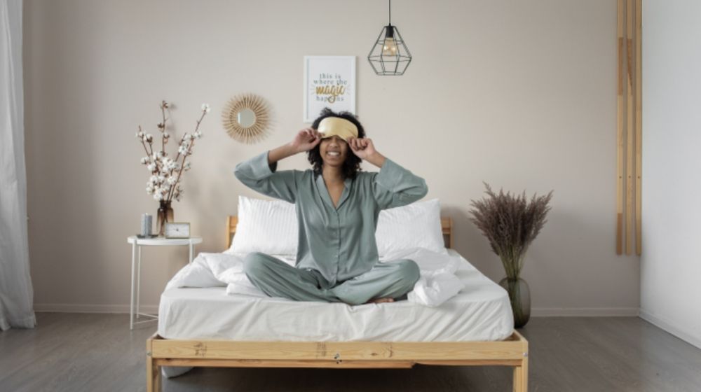 Photo by EKATERINA  BOLOVTSOVA: https://www.pexels.com/photo/woman-in-pajamas-sitting-on-a-bed-7445143/