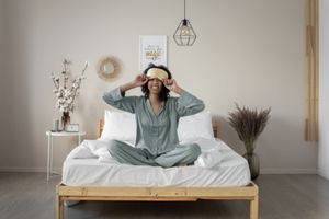 Photo by EKATERINA  BOLOVTSOVA: https://www.pexels.com/photo/woman-in-pajamas-sitting-on-a-bed-7445143/