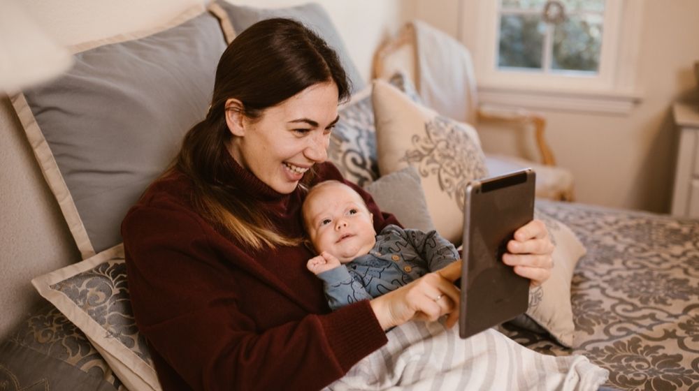 Photo by RODNAE Productions: https://www.pexels.com/photo/mother-holding-her-baby-while-having-a-video-call-using-a-tablet-6414703/