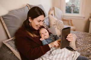 Photo by RODNAE Productions: https://www.pexels.com/photo/mother-holding-her-baby-while-having-a-video-call-using-a-tablet-6414703/