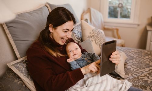 Photo by RODNAE Productions: https://www.pexels.com/photo/mother-holding-her-baby-while-having-a-video-call-using-a-tablet-6414703/