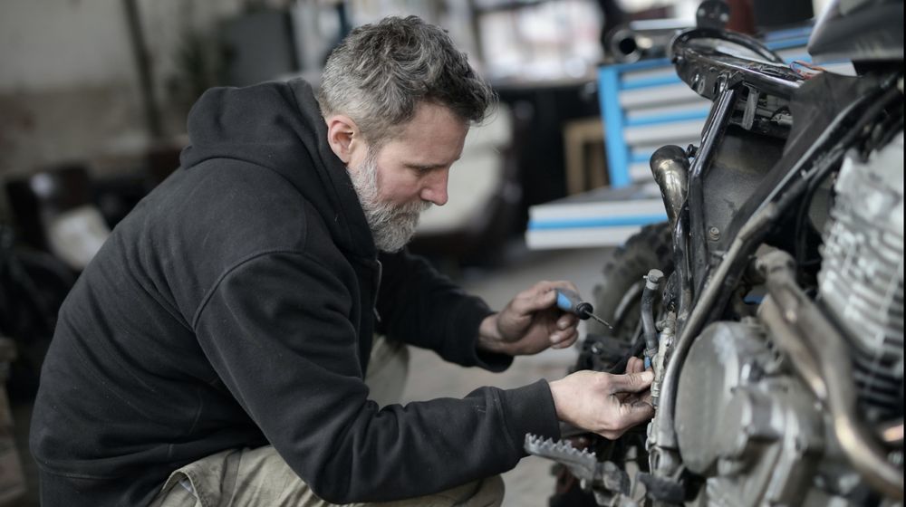 Photo by Andrea Piacquadio: https://www.pexels.com/photo/bearded-man-fixing-motorcycle-in-workshop-3822843/