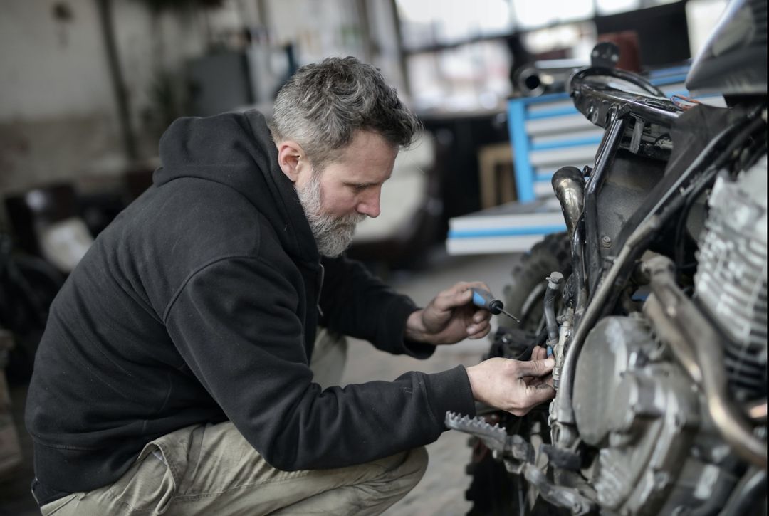 Photo by Andrea Piacquadio: https://www.pexels.com/photo/bearded-man-fixing-motorcycle-in-workshop-3822843/