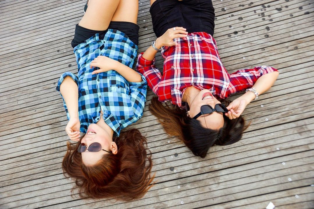 Photo by Gianne Karla Tolentino: https://www.pexels.com/photo/two-woman-wearing-blue-and-red-sport-shirts-and-sunglasses-lying-on-brown-surface-58592/