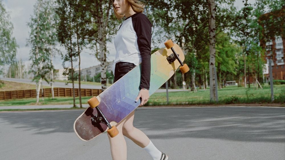 Photo by cottonbro studio: https://www.pexels.com/photo/woman-in-white-and-black-long-sleeve-shirt-holding-a-longboard-5026425/