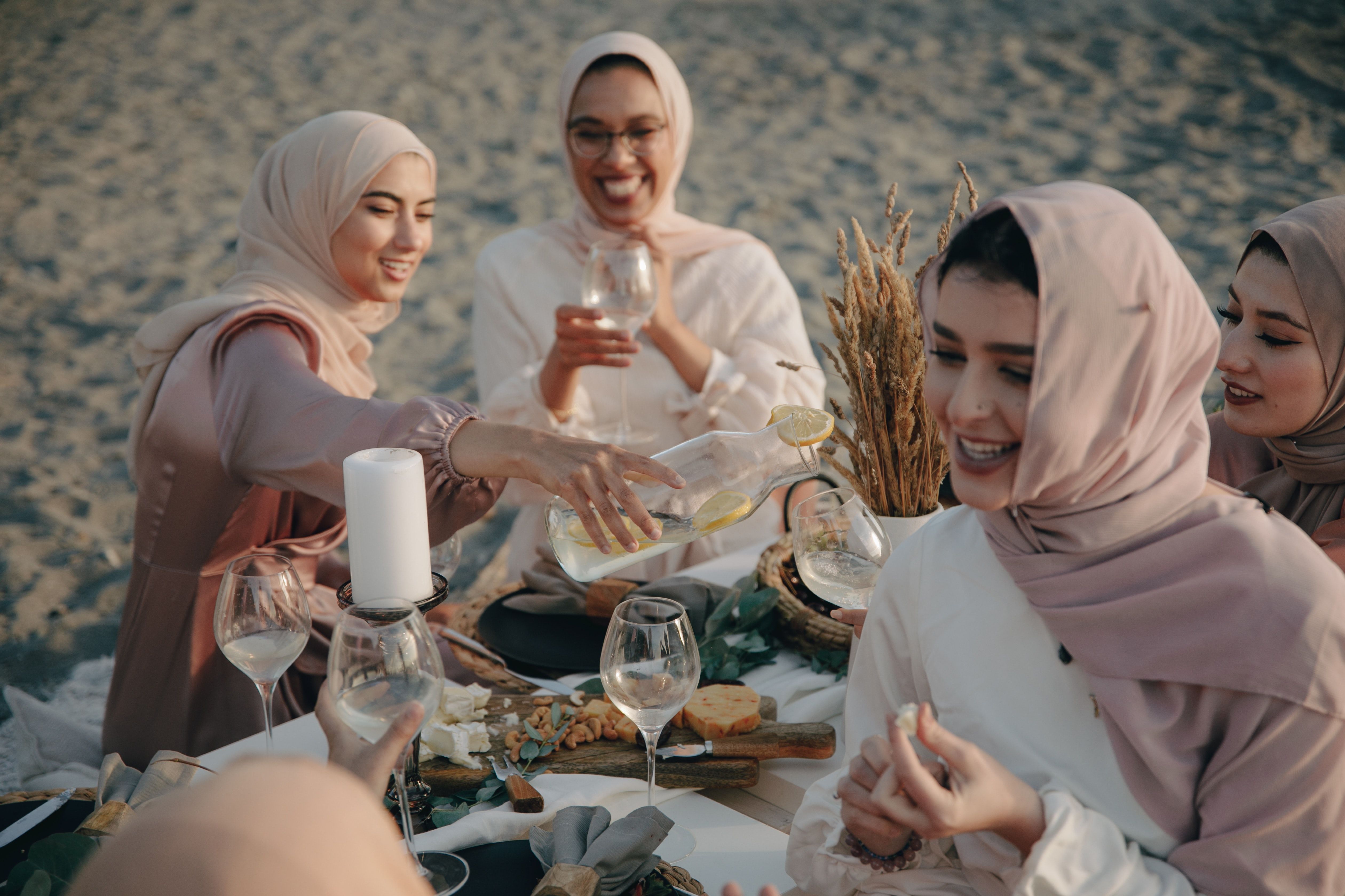 Photo by PNW Production: https://www.pexels.com/photo/group-of-women-wearing-hijab-sitting-on-beach-sand-drinking-and-celebrating-8995838/