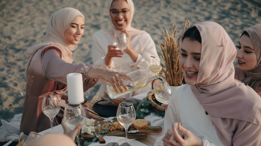 Photo by PNW Production: https://www.pexels.com/photo/group-of-women-wearing-hijab-sitting-on-beach-sand-drinking-and-celebrating-8995838/