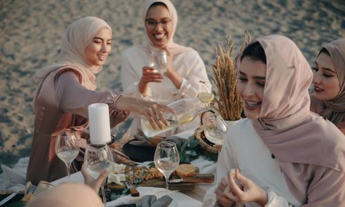 Photo by PNW Production: https://www.pexels.com/photo/group-of-women-wearing-hijab-sitting-on-beach-sand-drinking-and-celebrating-8995838/