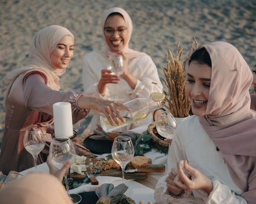 Photo by PNW Production: https://www.pexels.com/photo/group-of-women-wearing-hijab-sitting-on-beach-sand-drinking-and-celebrating-8995838/