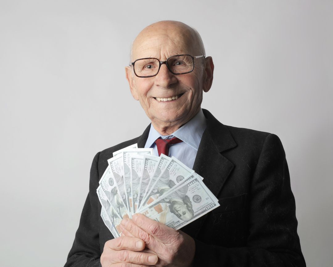 Photo by Andrea Piacquadio: https://www.pexels.com/photo/man-in-black-suit-holding-dollar-bills-3831181/