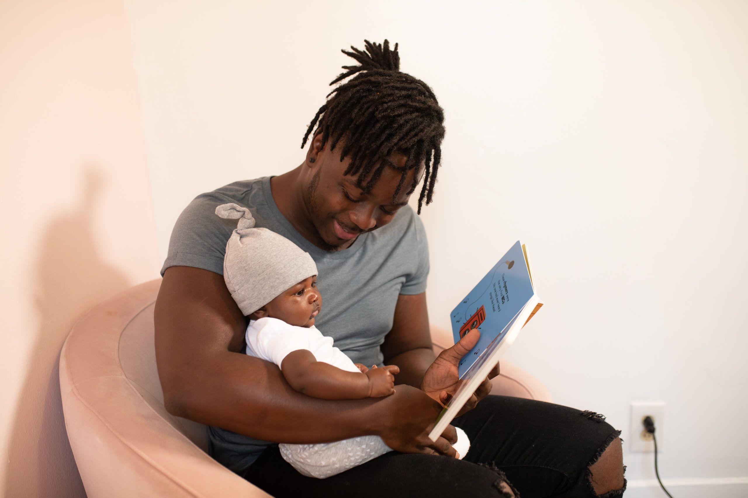 Photo by nappy: https://www.pexels.com/photo/a-father-reading-a-book-to-his-baby-3536643/