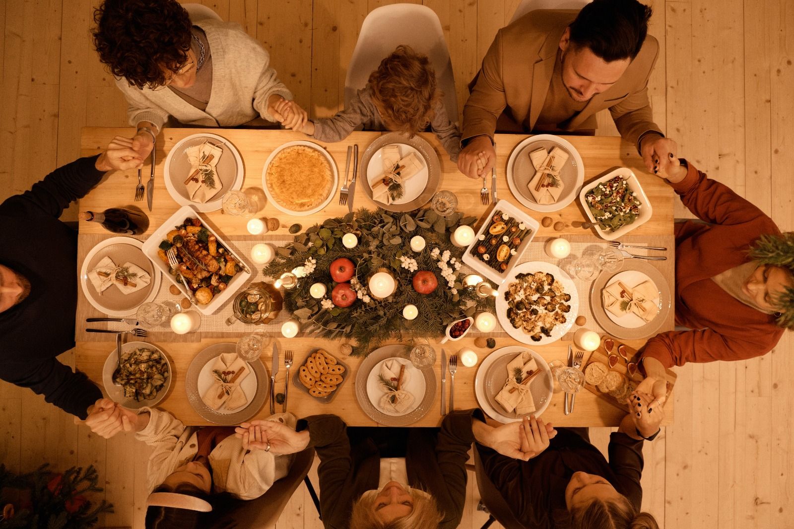 Photo by Nicole Michalou : https://www.pexels.com/photo/top-view-of-a-family-praying-before-christmas-dinner-5779170/
