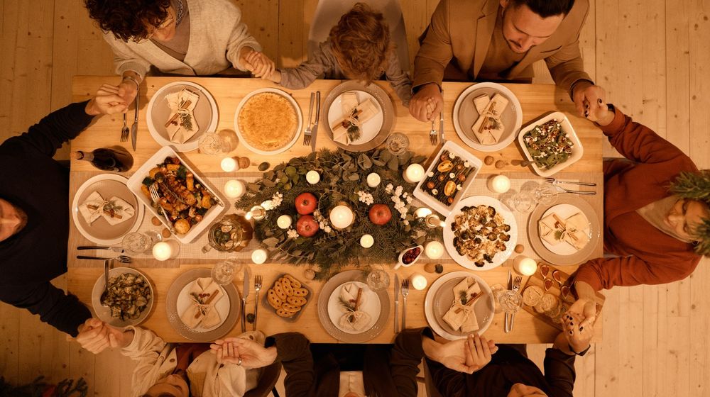 Photo by Nicole Michalou : https://www.pexels.com/photo/top-view-of-a-family-praying-before-christmas-dinner-5779170/