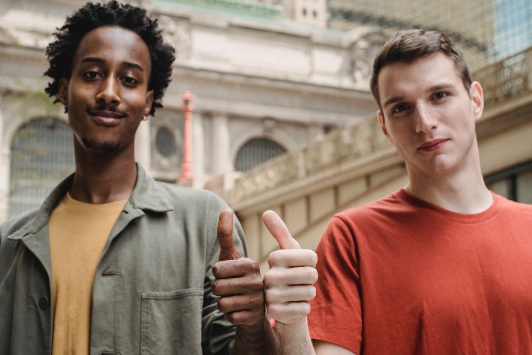 Photo by William  Fortunato : https://www.pexels.com/photo/positive-young-multiracial-guys-demonstrating-thumbs-up-sign-at-camera-6140715/