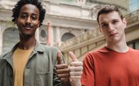 Photo by William  Fortunato : https://www.pexels.com/photo/positive-young-multiracial-guys-demonstrating-thumbs-up-sign-at-camera-6140715/