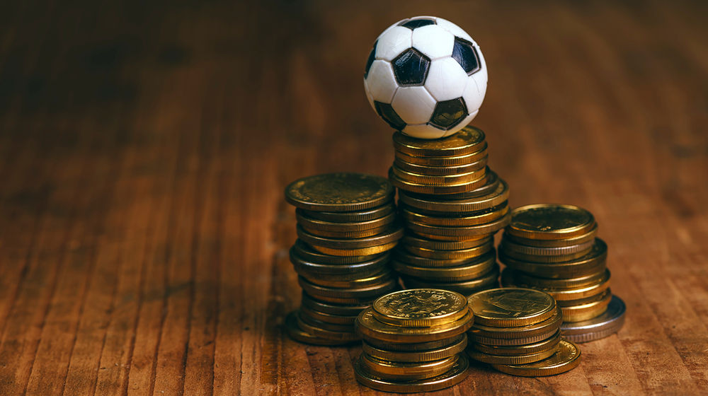 Soccer-bet-concept-with-football-and-money.png