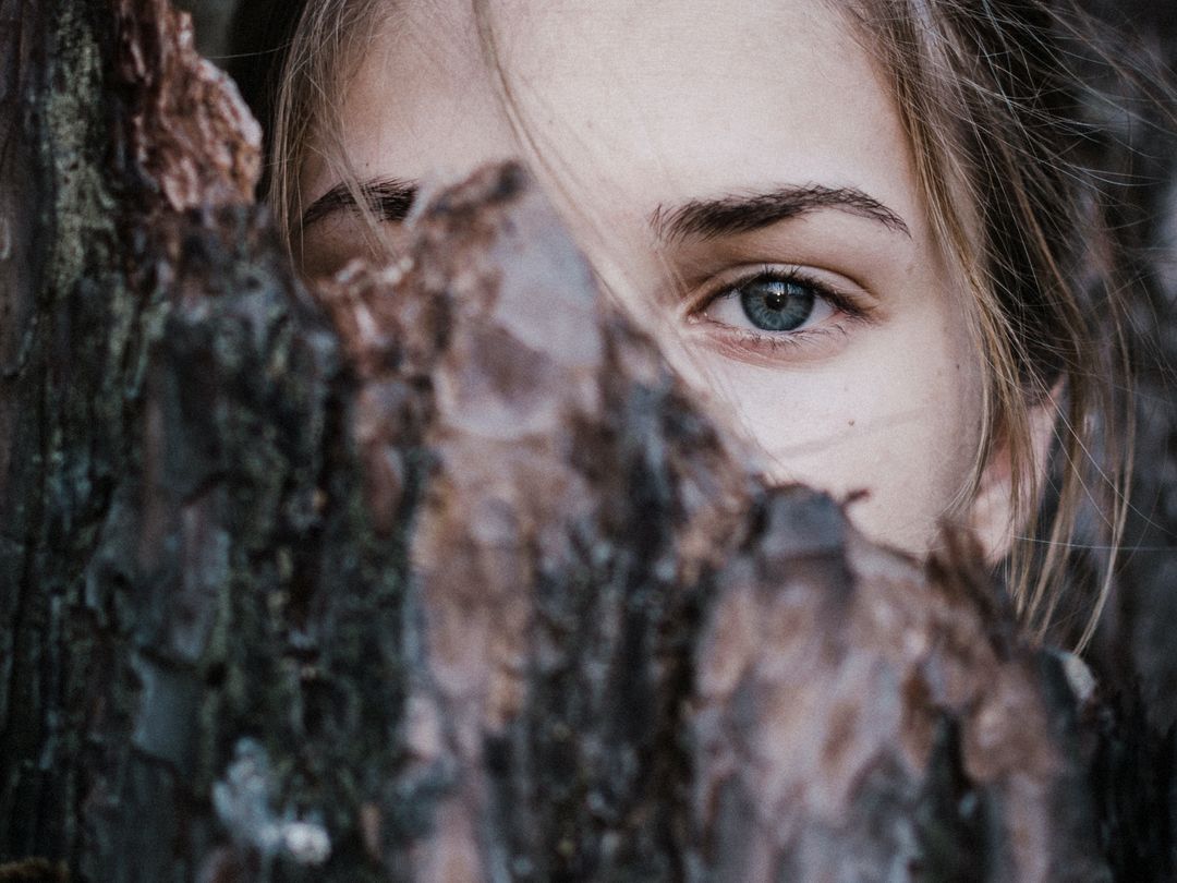 Photo by Elizaveta Dushechkina: https://www.pexels.com/photo/calm-woman-behind-tree-bark-in-park-3727149/