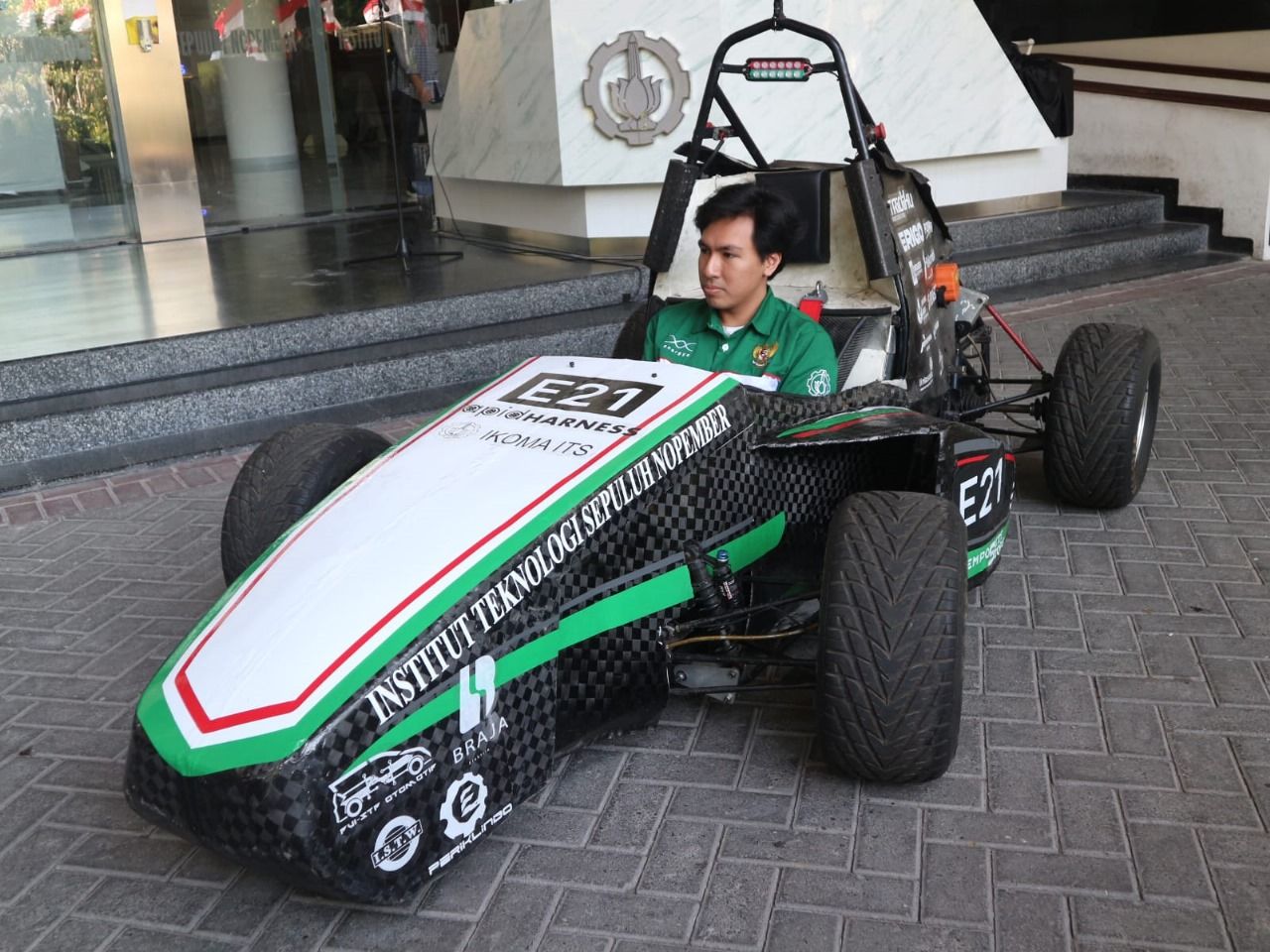 Dhaifan Wira Laksono dari Departemen Teknik Elektro ITS selaku driver tim saat mencoba menaiki mobil Anargya EV Mark 3.0