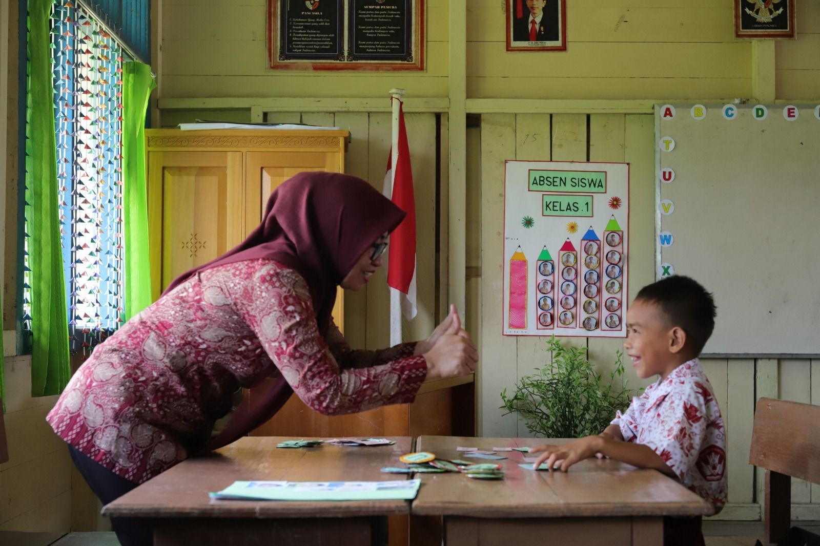 Seorang guru SD di Bulungan, Kalimantan Utara menggunakan media belajar sederhana untuk mengajarkan keterampilan membaca. Penggunaan media sederhana ini merupakan bagian dari pembelajaran berdiferensiasi yang menjadi ciri utama Kurikulum Merdeka. (Dok/Diskdikbud Bulungan)