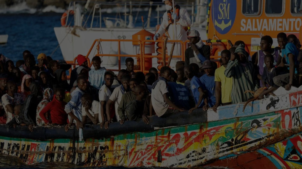 Sekelompok Migran dengan Perahu Kayu Ditarik oleh Kapal Penjaga Pantai Spanyol ke Pelabuhan Arguineguin