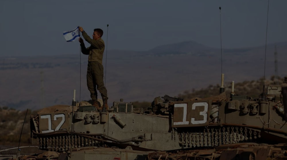 Seorang Tentara Memasang Bendera Israel di Sebuah Tank Selama Latihan Militer di Dekat Perbatasan Israel