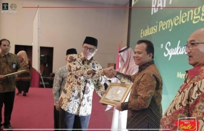 Ronny Sompie saat menerima penghargaan dari Menteri Agama. (Foto:Istimewa)