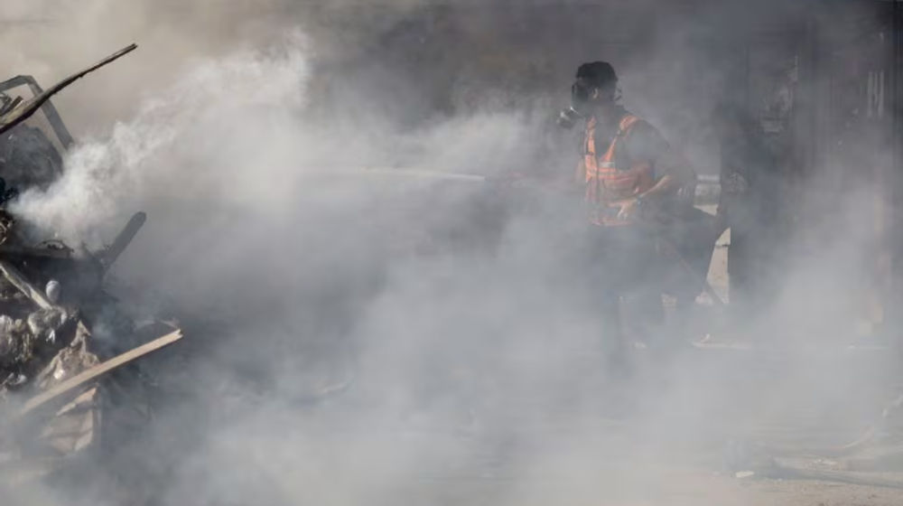 Seorang Petugas Pemadam Kebakaran Palestina Bekerja untuk Memadamkan Api di Lokasi Serangan Israel di Sebuah Bangunan Tempat Tinggal