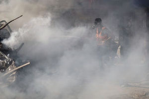 Seorang Petugas Pemadam Kebakaran Palestina Bekerja untuk Memadamkan Api di Lokasi Serangan Israel di Sebuah Bangunan Tempat Tinggal