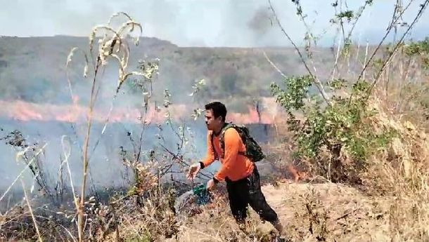 Babinsa Desa Mahekelan Serda Muwahidin Bersama Warga Padamkan Api yang Membakar Lahan Warga