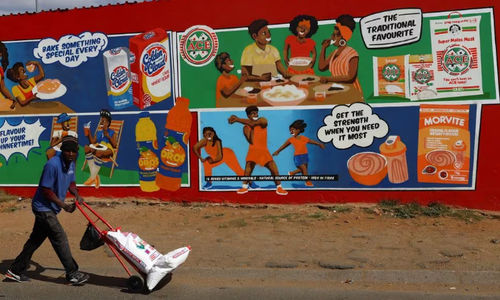 Seorang Pria Mendorong Troli Berisi Sekantong Tepung Jagung di Luar Toko Spaza di Thembisa, di East Rand, Afrika Selatan