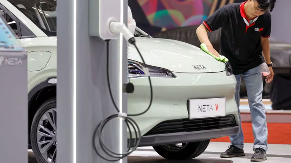 Seorang Pekerja Membersihkan Mobil Bertenaga Listrik Neta V, yang Dipajang di Gaikindo Indonesia International Auto Show di Tangerang