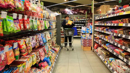 Seorang Pelanggan Memilih Produk di Sebuah Supermarket di Shanghai