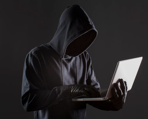 side-view-male-hacker-with-gloves-laptop.jpg