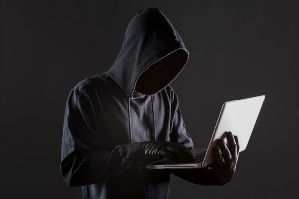 side-view-male-hacker-with-gloves-laptop.jpg