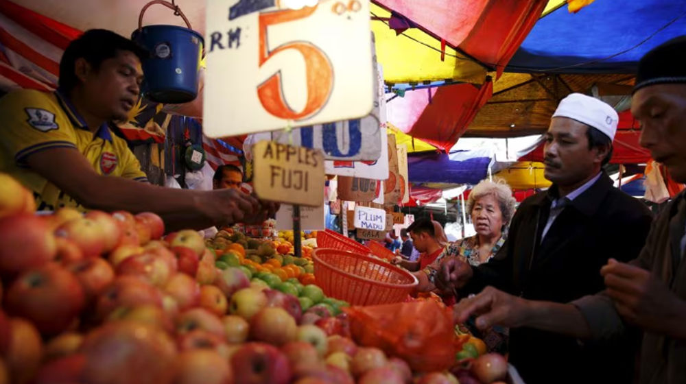 Orang-orang membeli buah-buahan di sebuah pasar di Kuala Lumpur, Malaysia