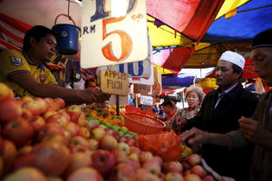 Orang-orang membeli buah-buahan di sebuah pasar di Kuala Lumpur, Malaysia