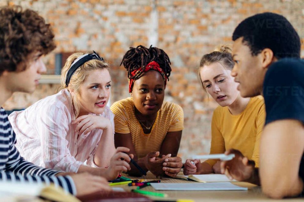 young-people-sitting-together-at-table-and-talking-SODF00108.jpg