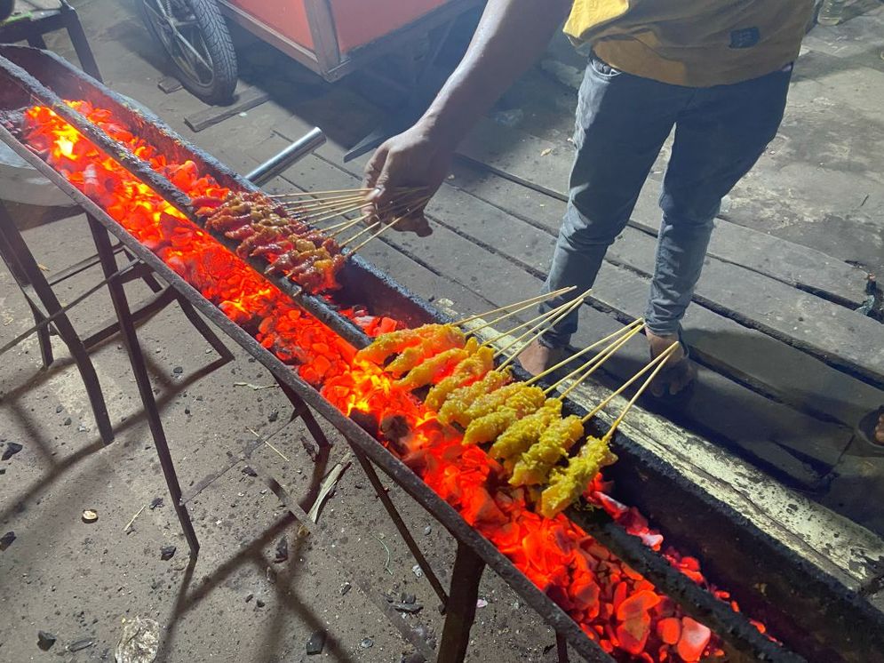 Proses pembakaran sate kelapa di atas bara api yang menyala, Palembang, Kamis (30/01/25).