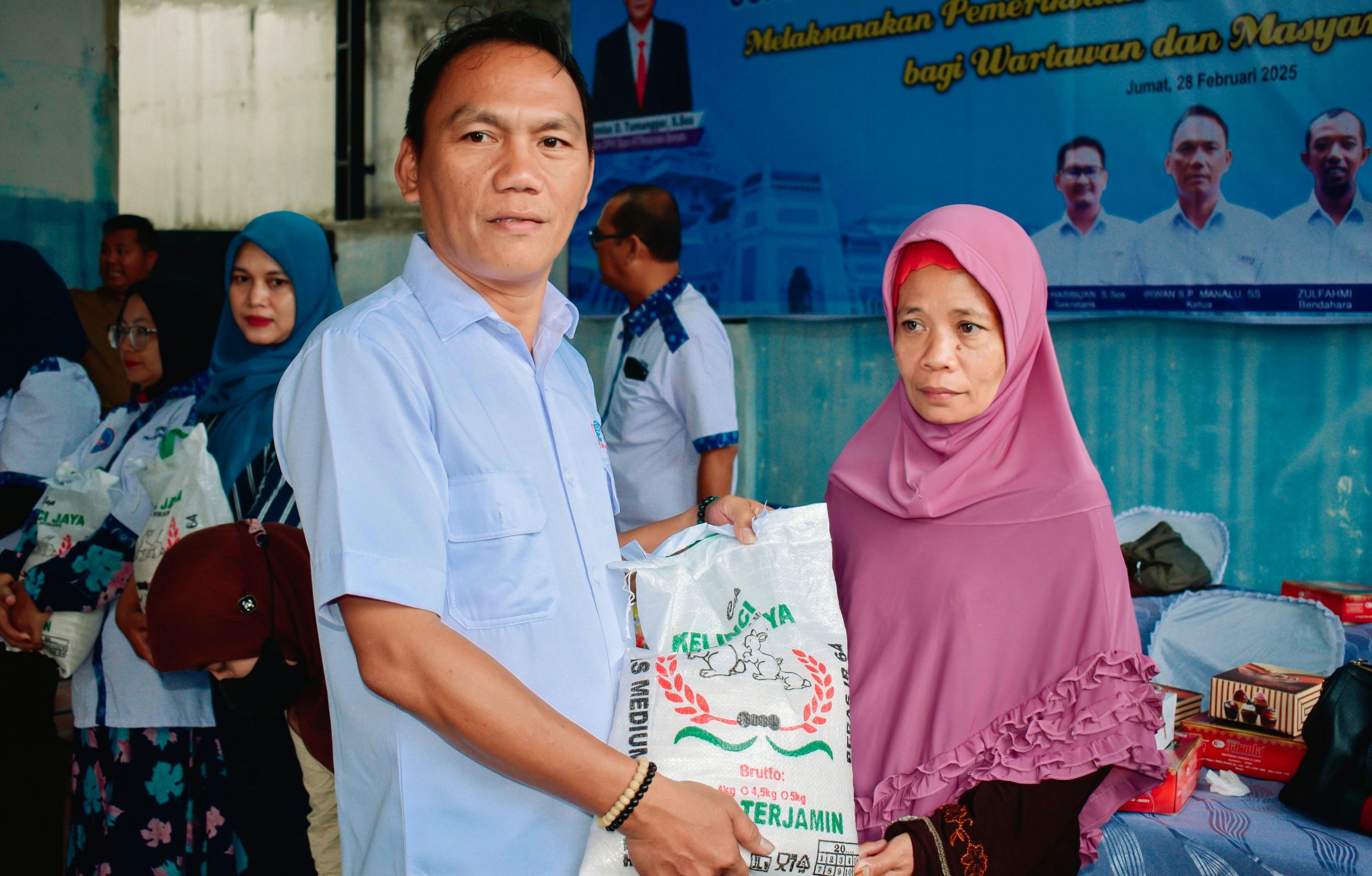 Ketua SMSI Kota Medan Irwan Manalu memberikan beras kepada masyarakat di PKG di Sopo ATRestorasi Bersatu