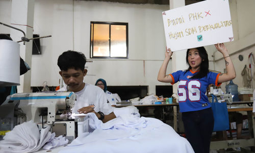 Sejumlah selebgram saat membawa poster penyemangat bagi pekerja dan pelaku UMKM konveksi di sebuah kawasan home industri tekstil Jakarta Selatan. Rabu 30 April 2025. Foto : Panji Asmoro/TrenAsia
