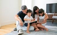 happy-parents-cute-kids-using-mobile-devices-floor-living-room_74855-8108.jpg