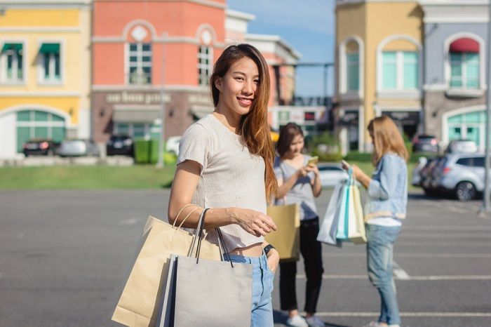 Ilustrasi wanita berbelanja sebagai bentuk self reward.